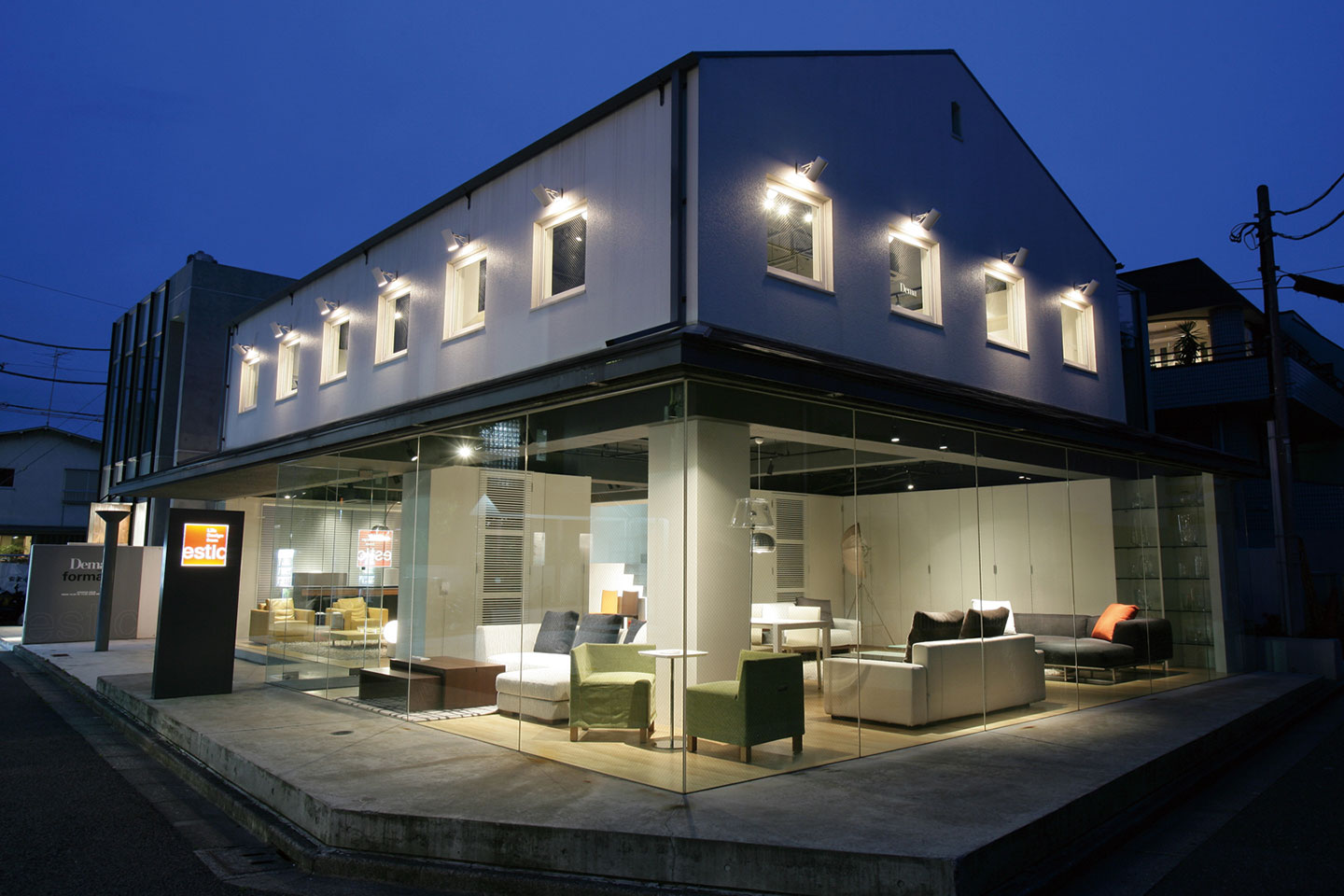 オリジン表参道店の夜間ショールーム、ガラス張りでソファが美しく展示されている